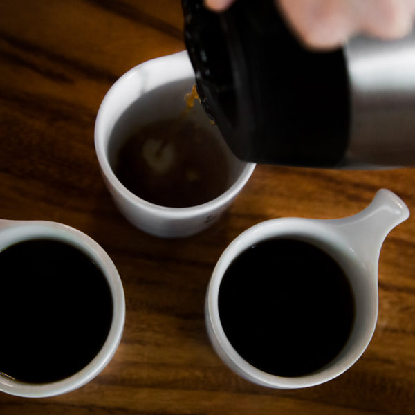 pouring coffee from carafe into cups